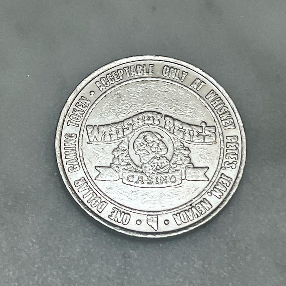Vintage Whiskey Pete's $1 one dollar casino gaming token from 1987
